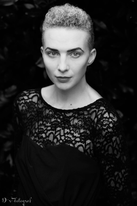 Black and White Portrait of a young, blonde, short haired woman in black lace dress